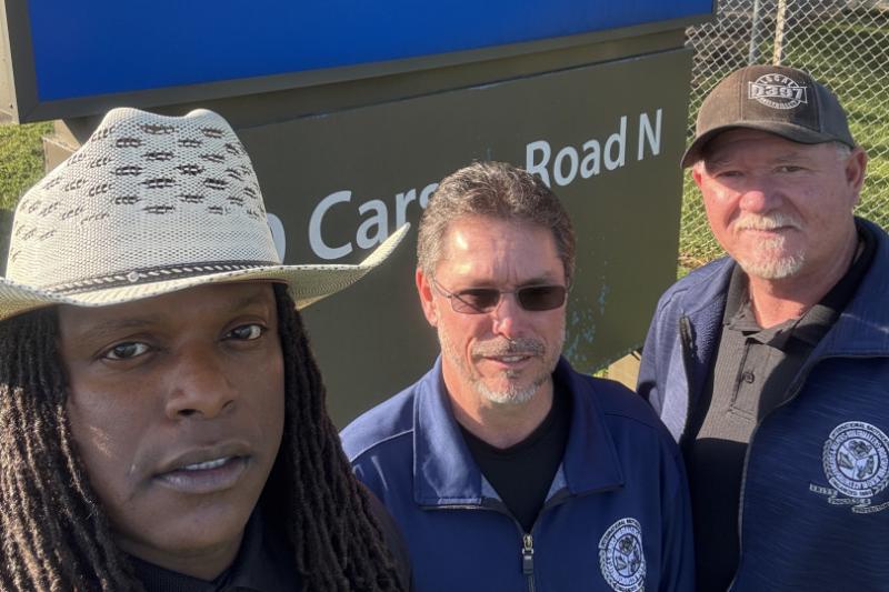 L. to r. SEO Carlos Brooks, ISO-ED Don Hamric and IR Mitch Beasley celebrate their union win in front of the Sherwin-Williams sign.